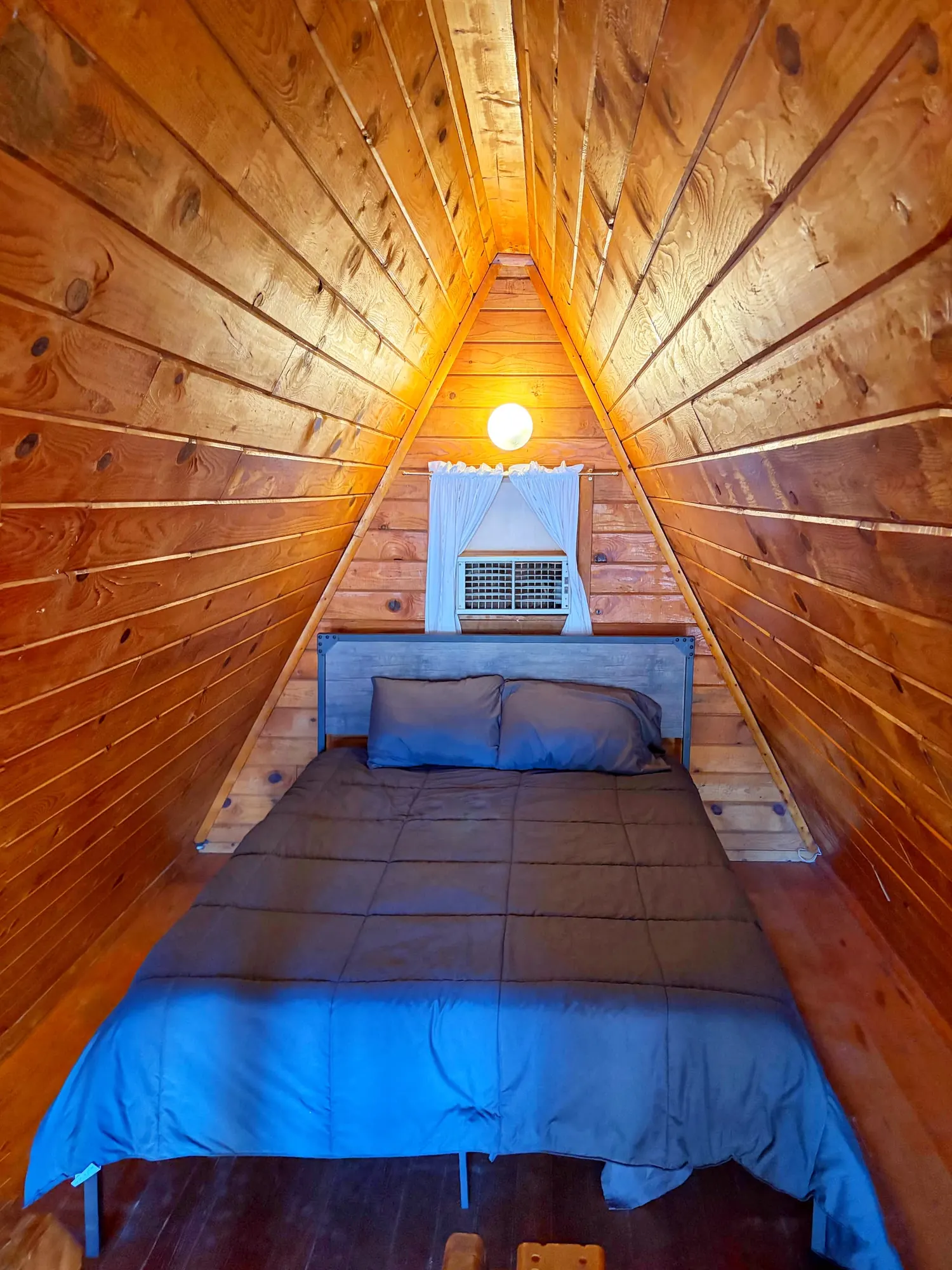 Queen sleeping area in the A-Frame Cabin loft