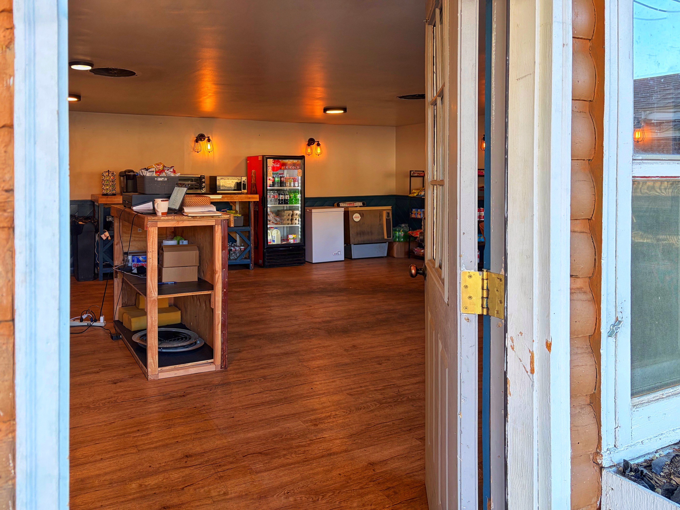 Open door of the Camp Store welcoming guests at Dark Sky River Lodge
